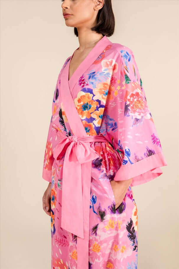 Woman wearing Cherry Blossom Cotton Robe in bubblegum pink with floral prints and tie belt
