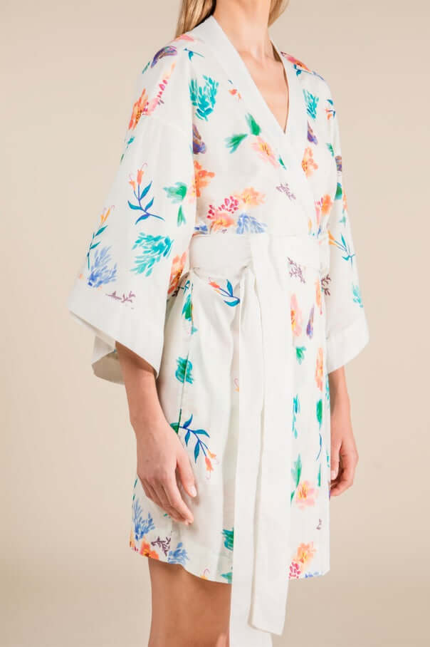Woman wearing Jasmine Cotton Robe with floral print, ivory short length, capturing Japanese cultural essence, 100% cotton.