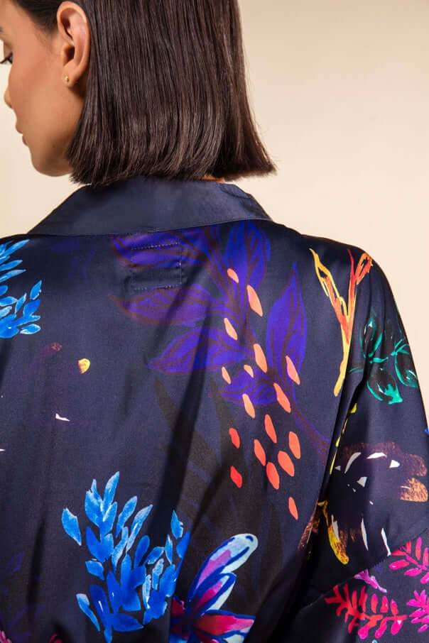 Back view of Chicory Silk Satin Robe featuring vibrant floral design in electric blue, pink, red, and orange on navy fabric.