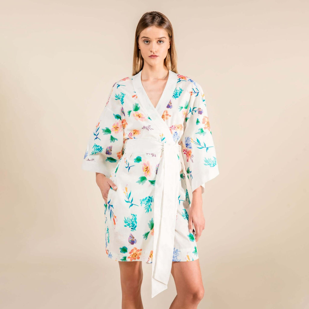 Woman wearing Jasmine Cotton Robe with floral print on ivory fabric, capturing essence of Japanese culture. 100% cotton, short length.