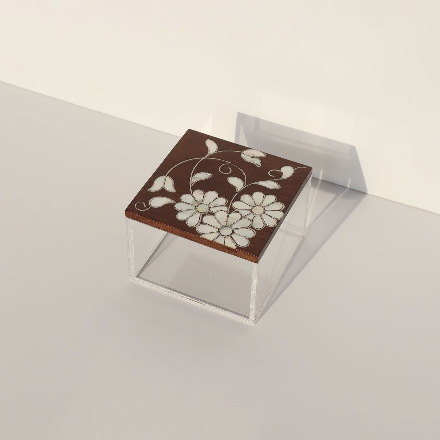 Small Plexi Box with Floral Sadaf made of plexi and wood with mother of pearl floral design on brown lid for elegant storage.