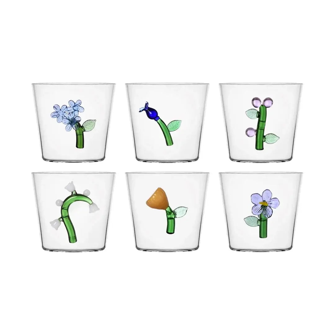 Botanica Tumblers Bundle with flower motifs in blue, pink, white, amber, and lilac. Handcrafted glassware for elegant dining.